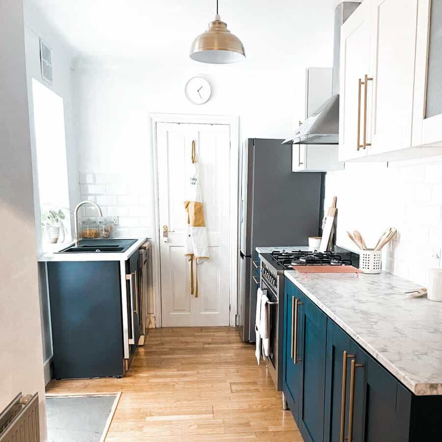 Small galley kitchen with gold fixtures