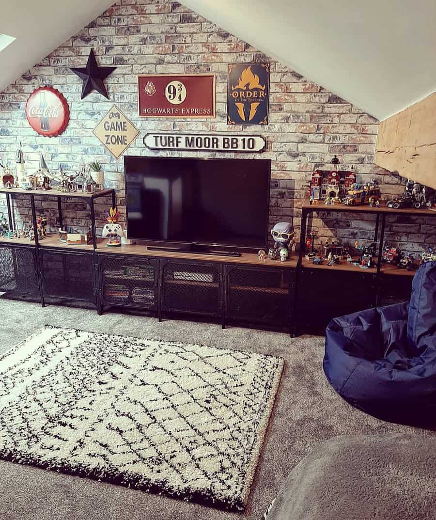 Cozy attic entertainment room with a brick accent wall, TV, themed decor, storage shelves, and a bean bag for a relaxed vibe.