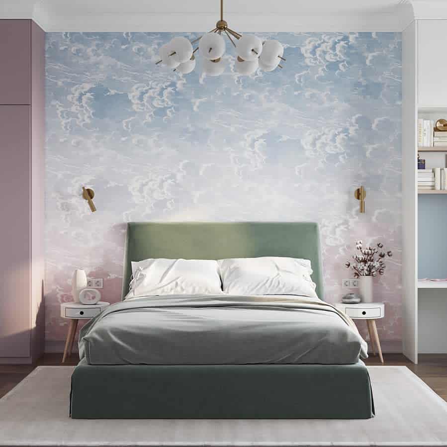 Bedroom with a cloud-patterned accent wall, green upholstered bed, white linens, and modern light fixtures on each side. White shelves on the right