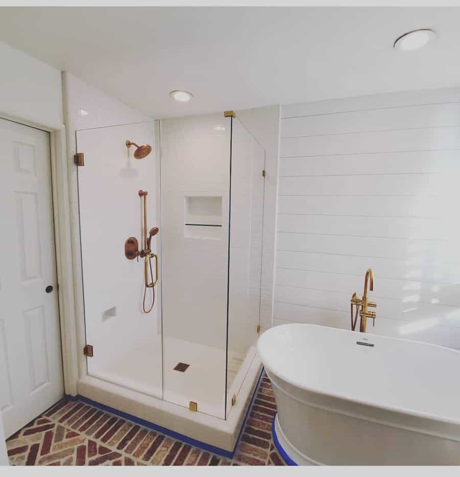bathroom shower with gold fixtures