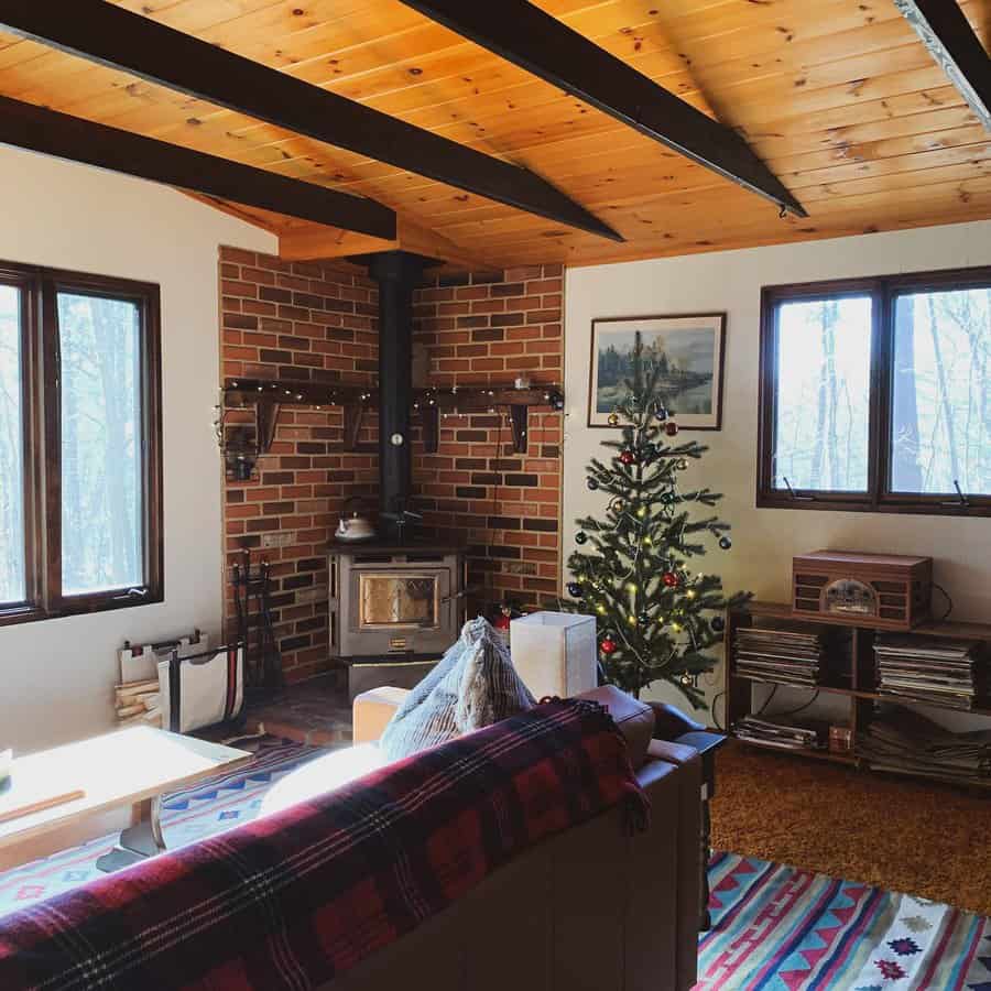 Cozy cabin interior with stove and Christmas tree