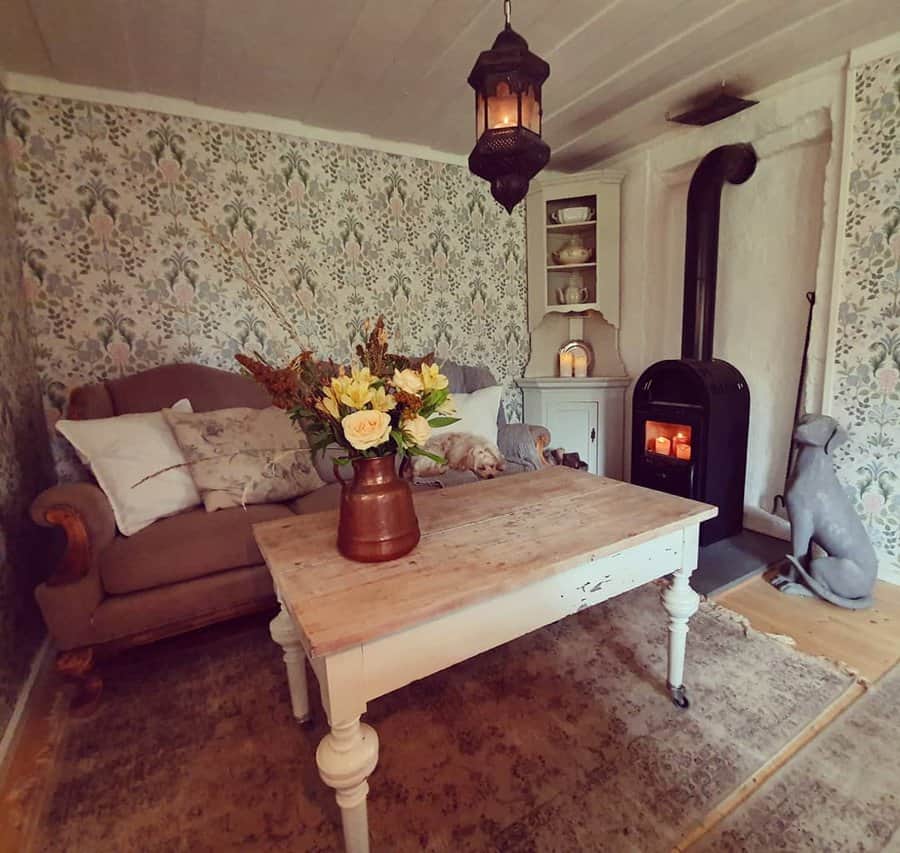 Vintage room with floral wallpaper and wood stove