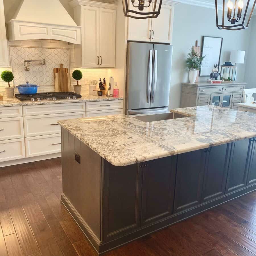 Elegant kitchen with marble island and white cabinetry