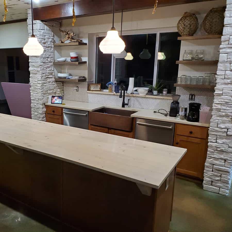 Rustic kitchen bar with stone column and pendant lights