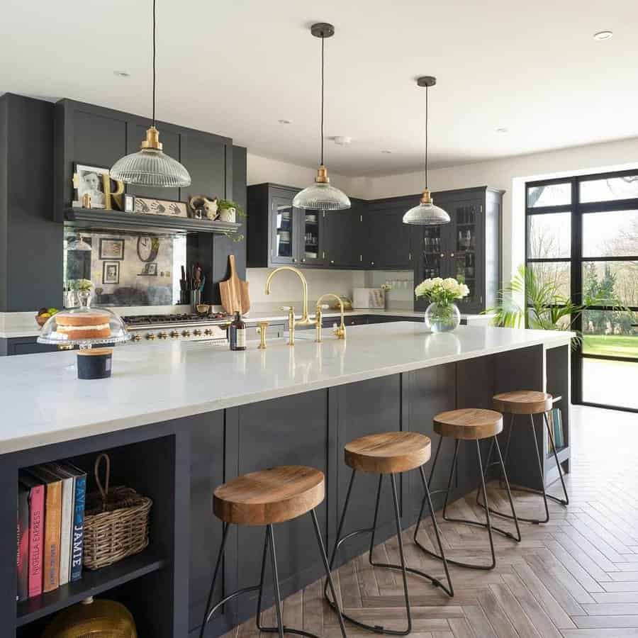 Modern black kitchen with counter stools and pendant lights