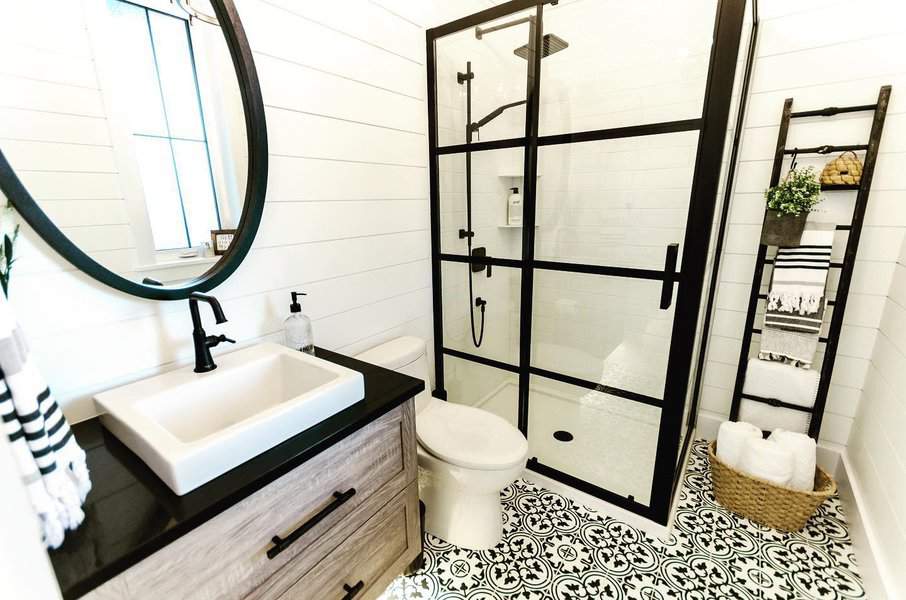 Stylish bathroom with patterned floor and shiplap walls