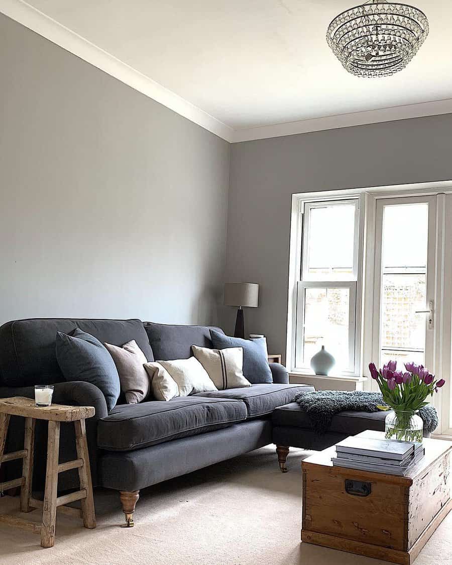 Minimalist living room with grey sofa and crystal chandelier