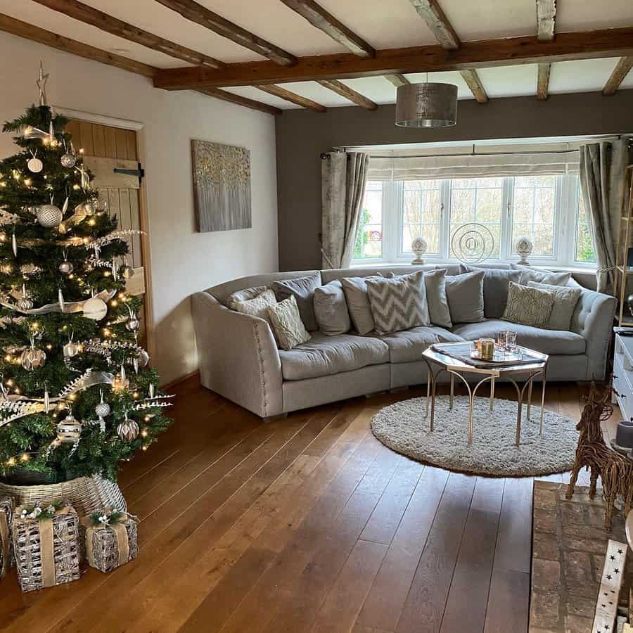 Holiday living room with tree and exposed ceiling beams