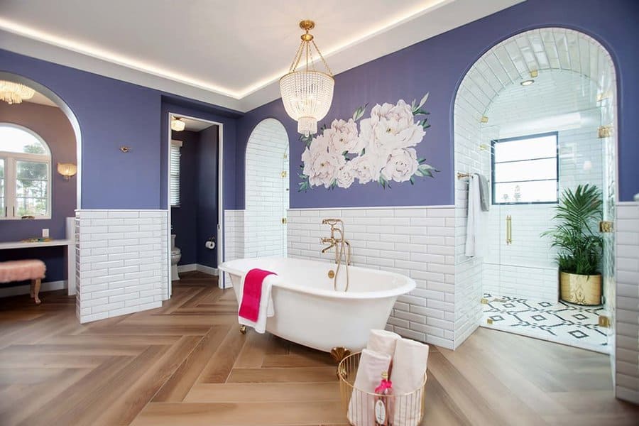 Elegant bathroom with a tray ceiling, soft cove lighting, rich blue walls, and gold accents, creating a luxurious and stylish retreat.