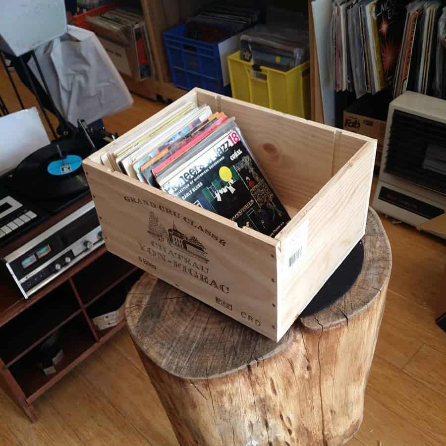 Wooden crate on stump with vinyl collection