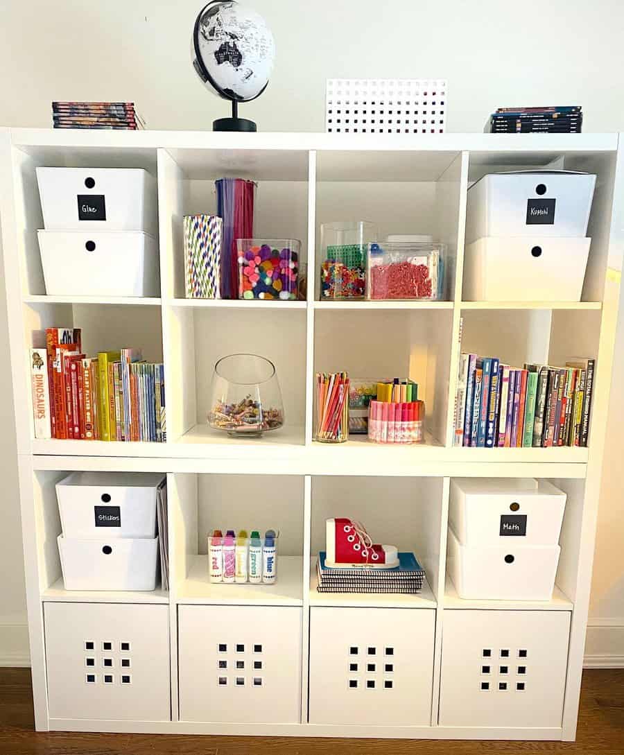 White cubby shelf with labeled craft bins