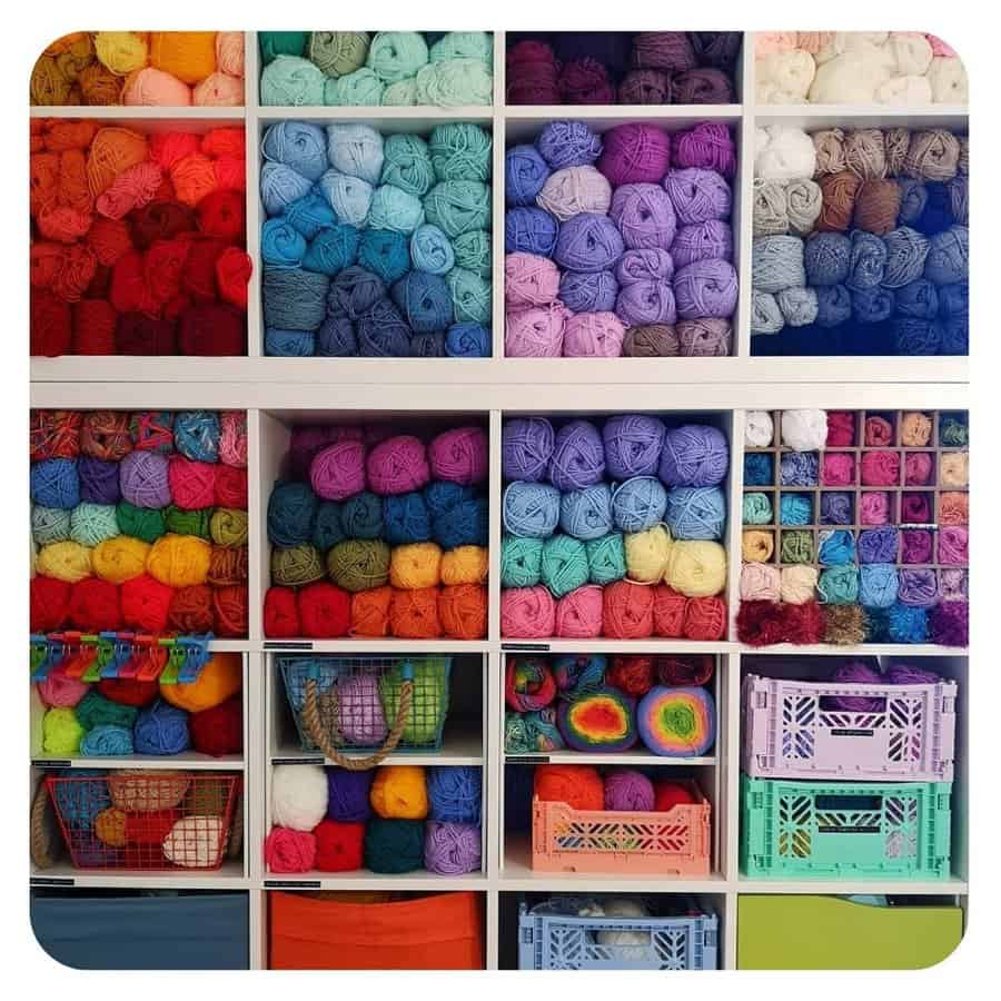 Colorful yarn organized in white cubbies