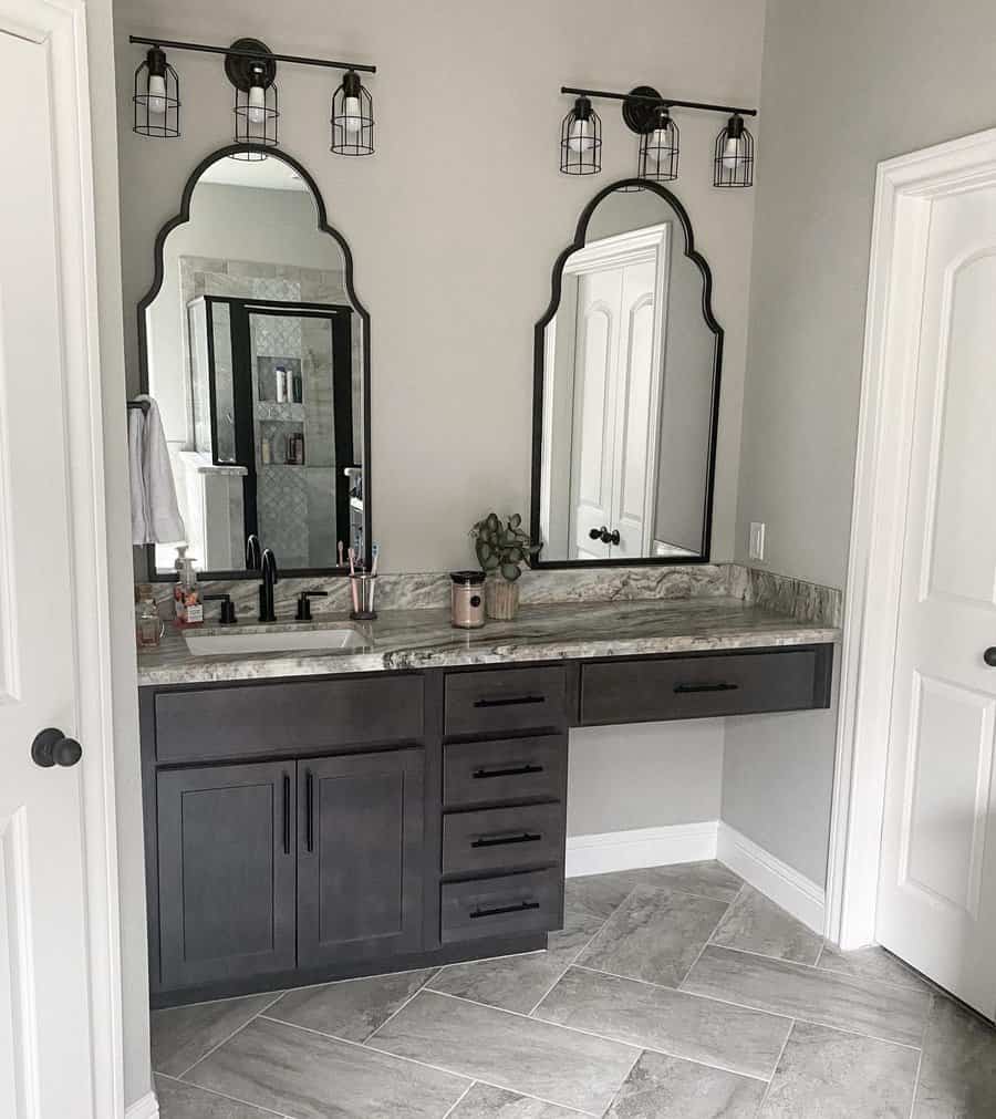bathroom vanity with arch wall mirror and marble countertop