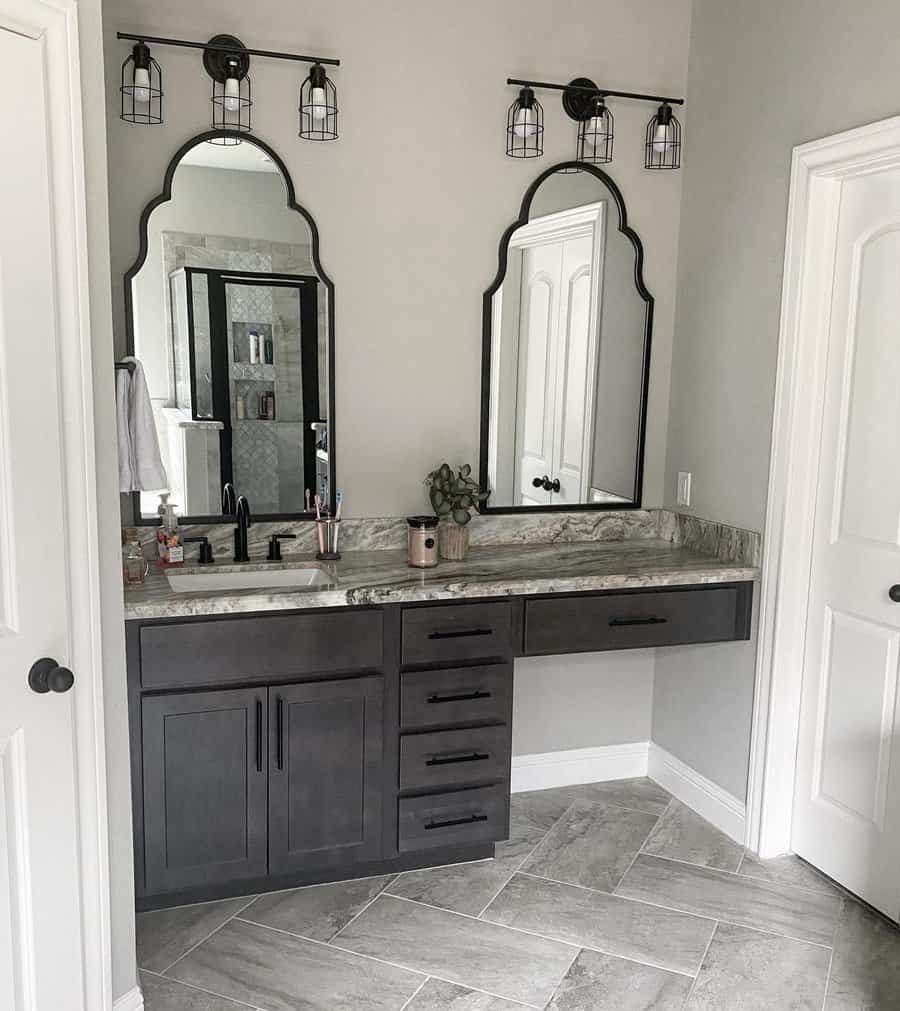 Gray vanity with marble top and arched mirrors