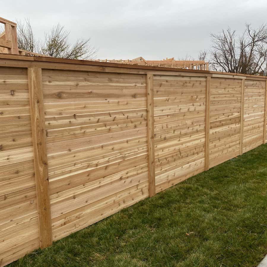 Richly hued wooden horizontal fence with supportive posts