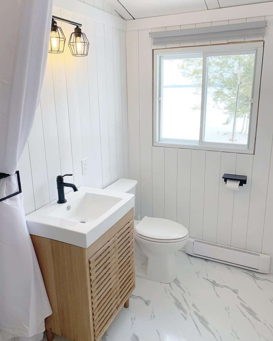 Bright bathroom with wood vanity and snow view