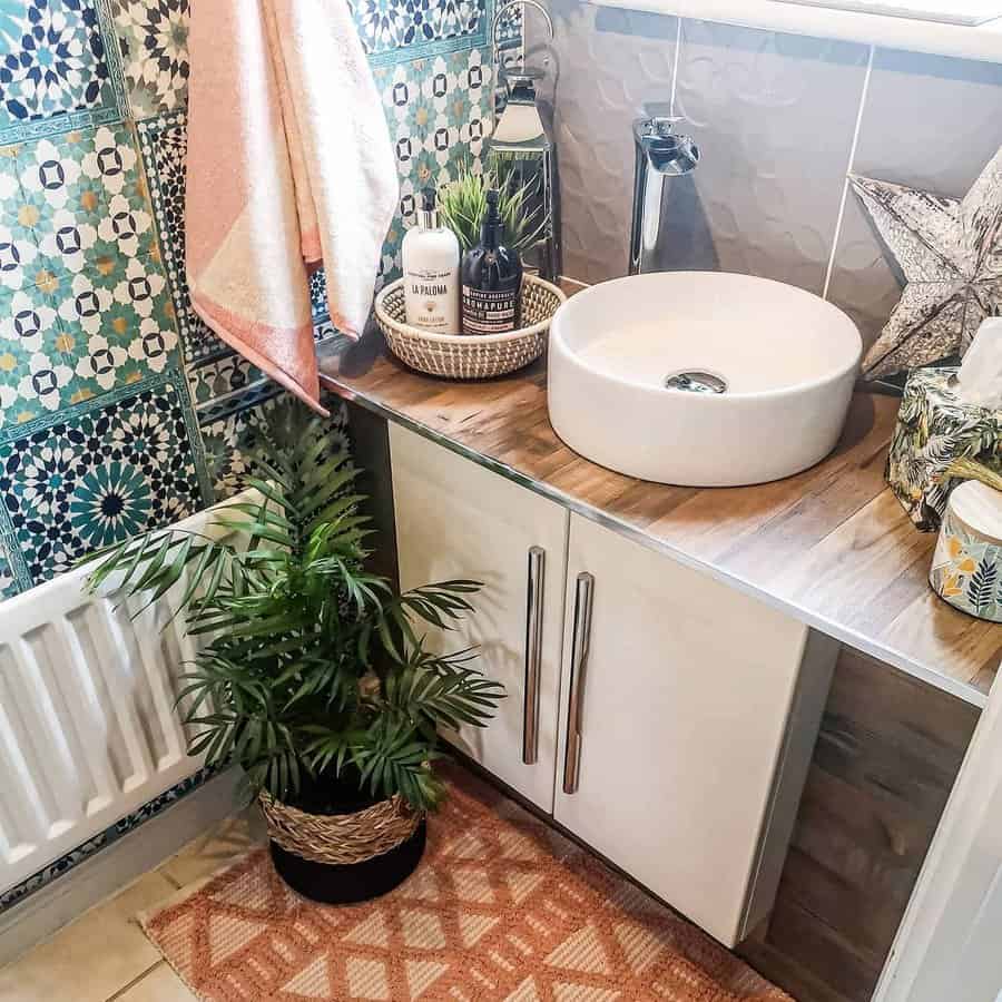 Eclectic vanity with patterned tiles and plants