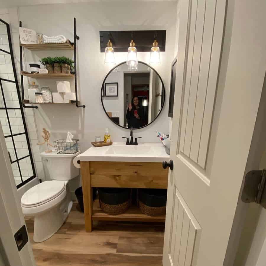 Chic bathroom with round mirror and open vanity