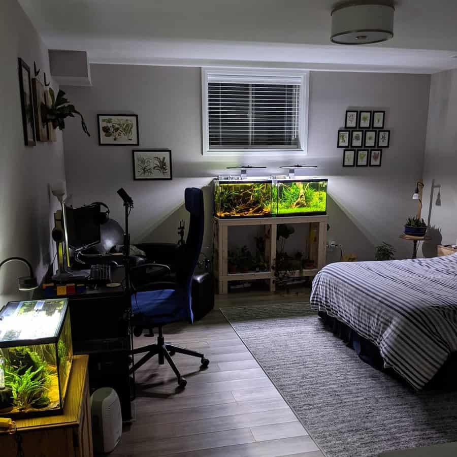 Unique bedroom office with a gaming setup, multiple aquariums, and cozy lighting, blending work, relaxation, and a love for nature