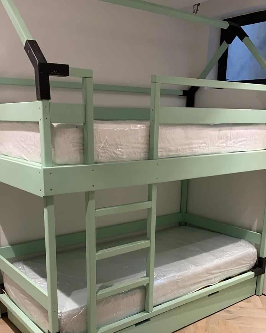 Mint green wooden bunk bed with built-in ladder and safety rails, featuring clean lines and a modern, minimalist design