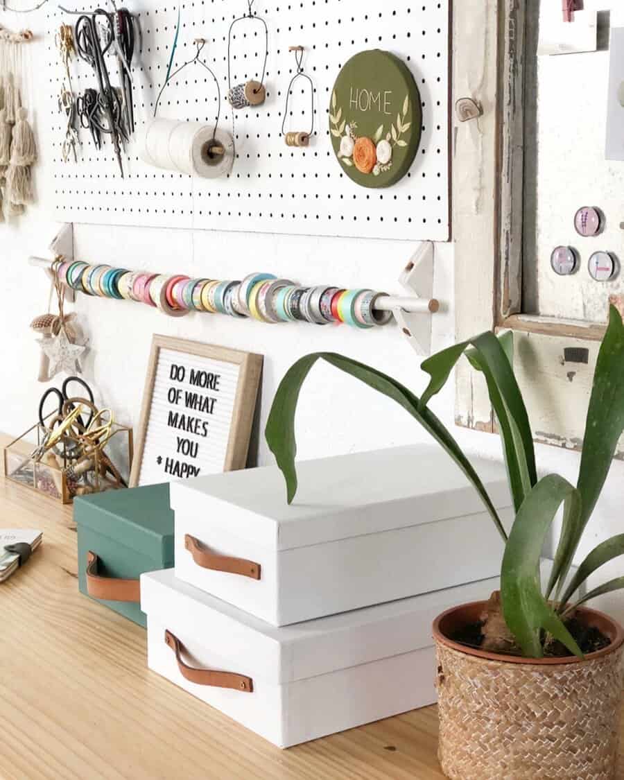 Minimalist craft desk with pegboard and storage boxes