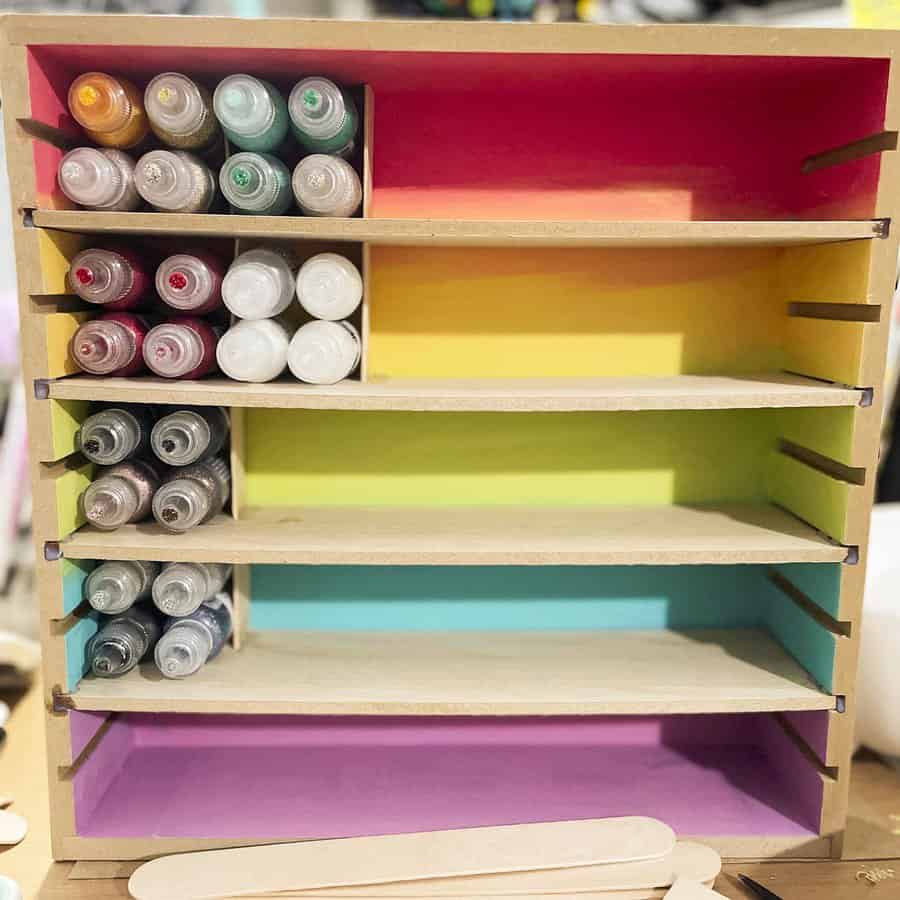 Colorful paint bottle rack on craft desk