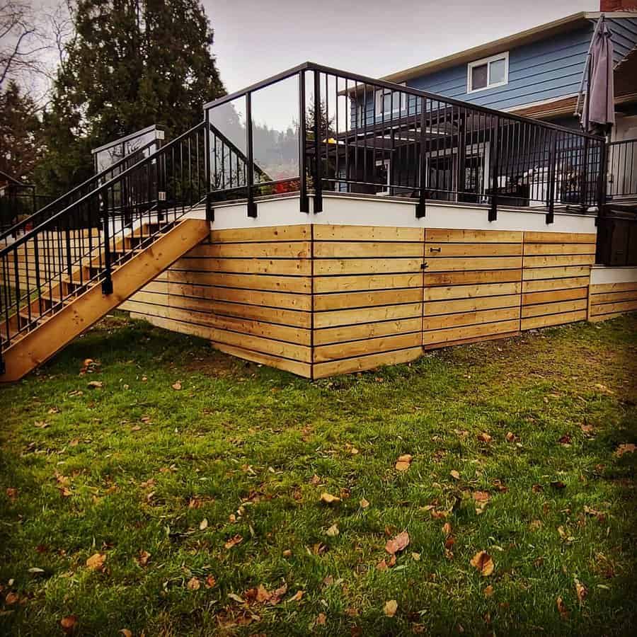 Elevated deck with horizontal wood skirting and black railings