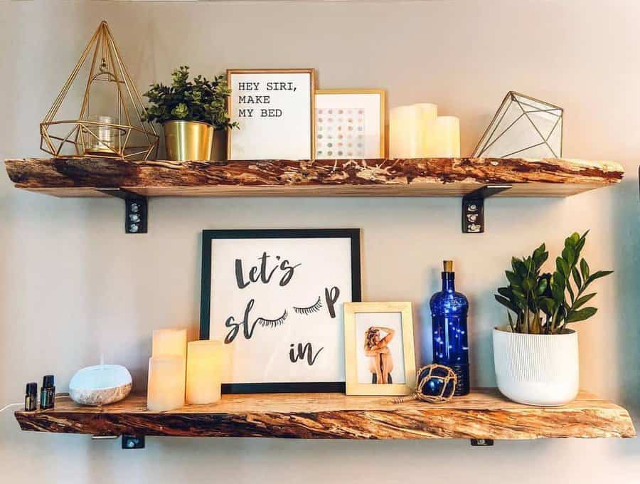 Wooden shelves with decor: plants, candles, framed quotes, bottles, and geometric accents on a beige wall; cozy and artistic setup