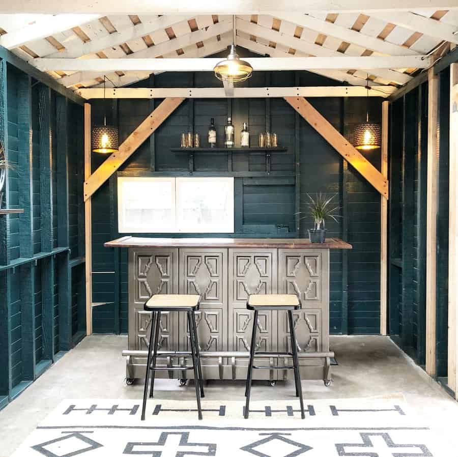 Rustic outdoor bar with industrial stools under a wooden pergola