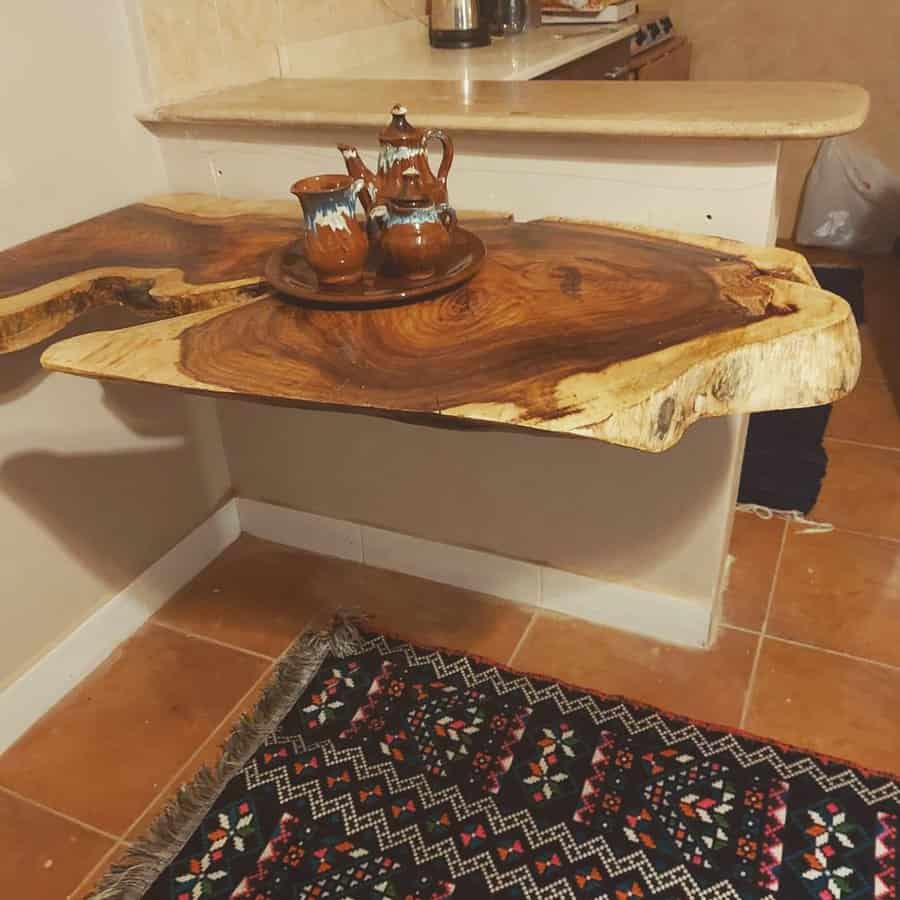 Live-edge wooden table with teapot set and a patterned rug