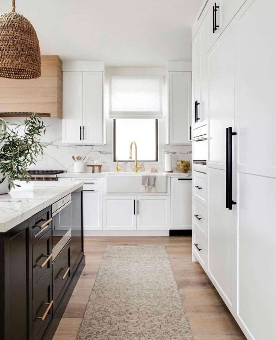 Modern kitchen with white cabinetry and marble counters