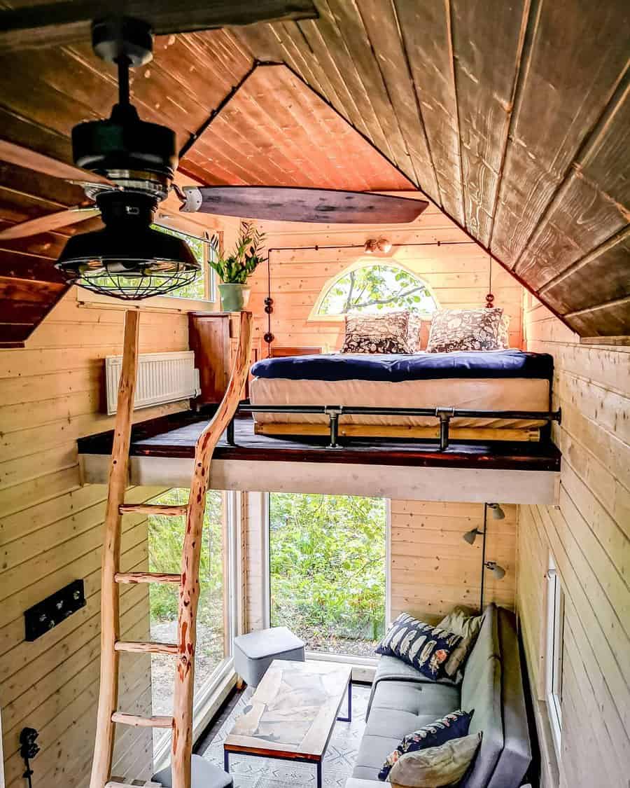 Cozy loft space with rustic ladder and window