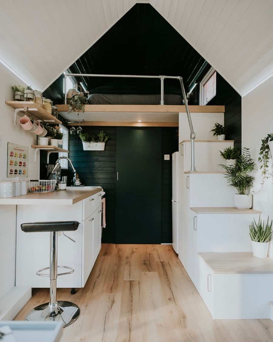 Modern kitchen with loft bed and white stairs