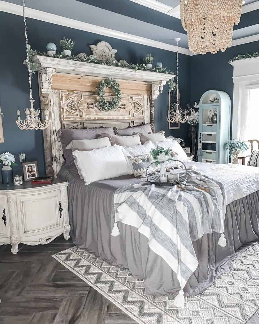 Rustic master bedroom with a reclaimed wood headboard, dark moody walls, and vintage decor, creating a cozy and elegant farmhouse retreat