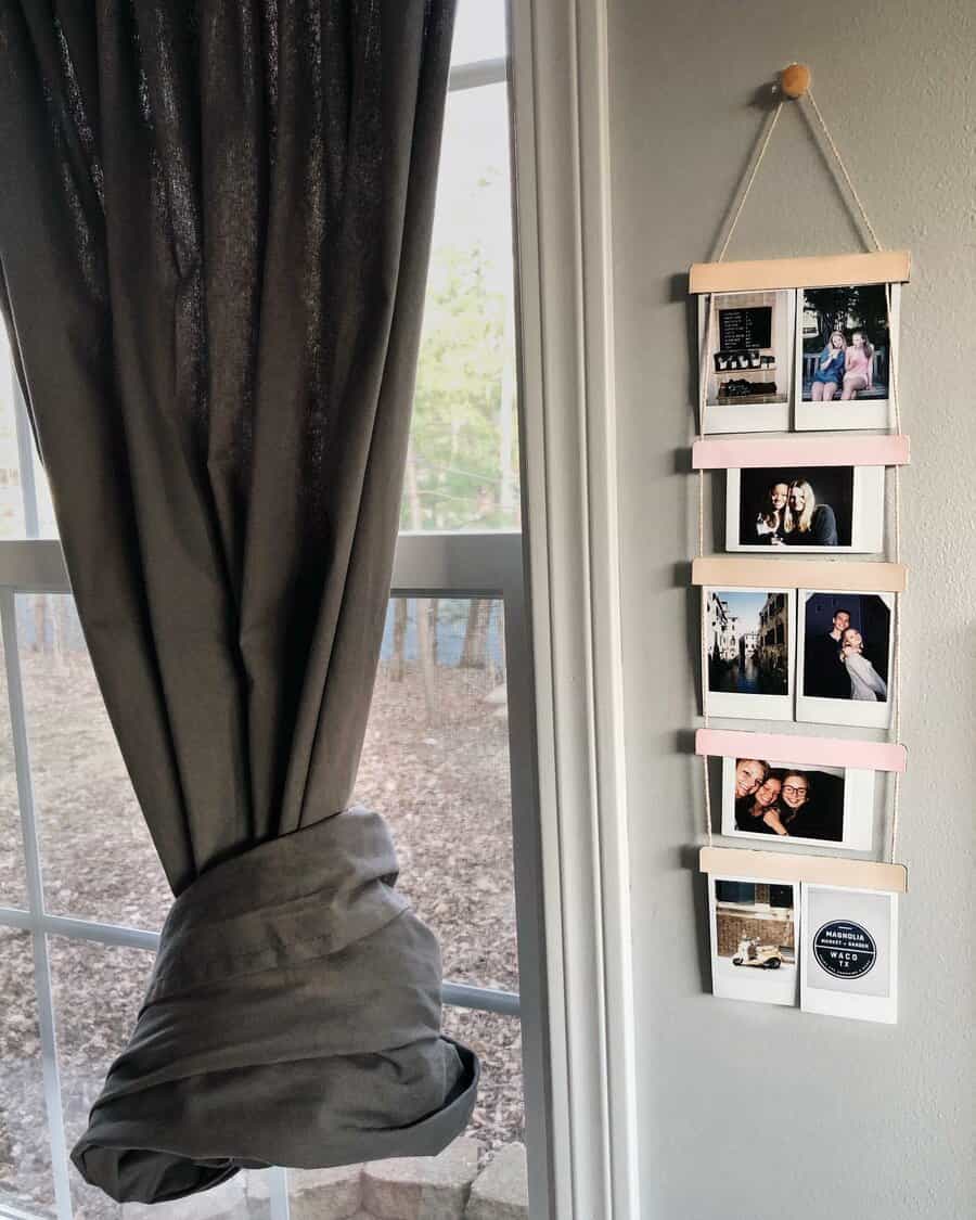 Hanging photo display with five Polaroid pictures next to a curtained window