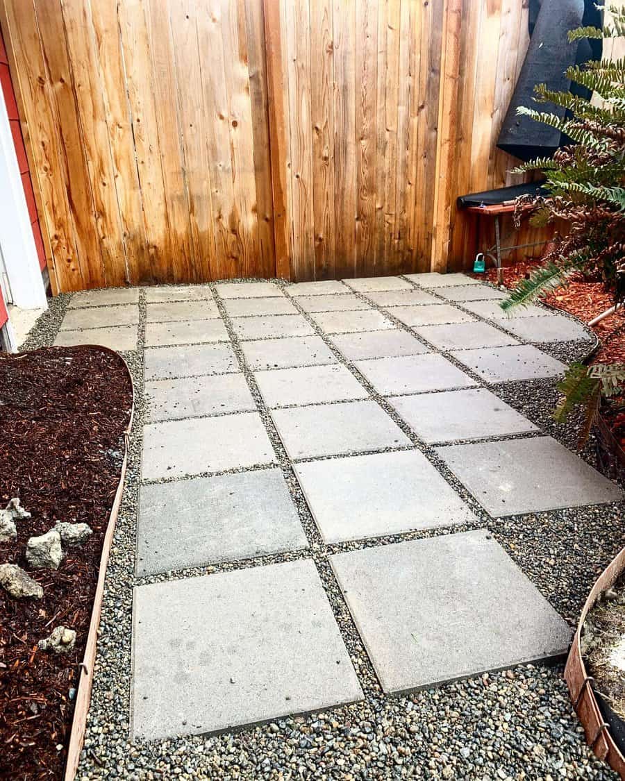 Patio with large square slabs and pebble inlays