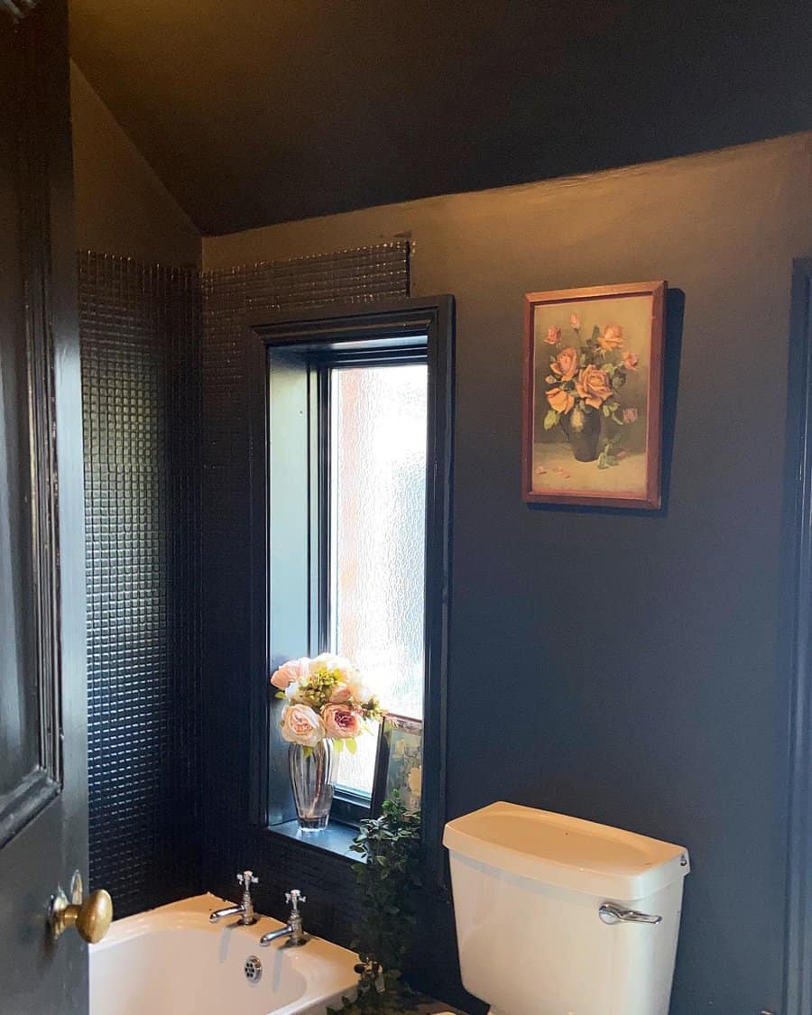 Moody bathroom with a dark ceiling and walls, vintage decor, and soft lighting, creating a dramatic yet cozy atmosphere with elegant details.