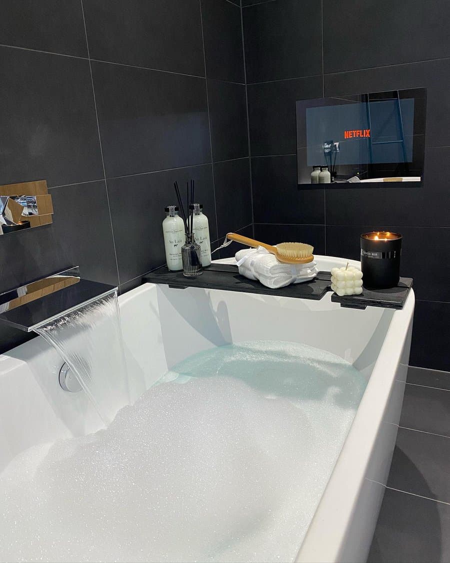 Modern bathroom with bubble bath and TV