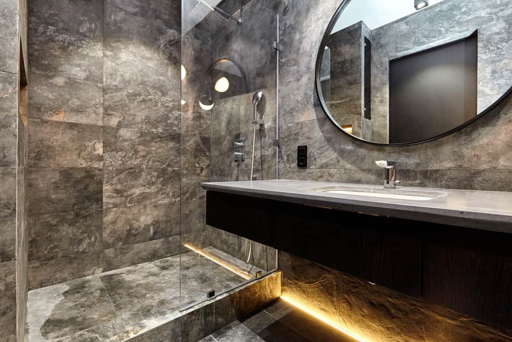 Dark gray bathroom with under lighting and mirror