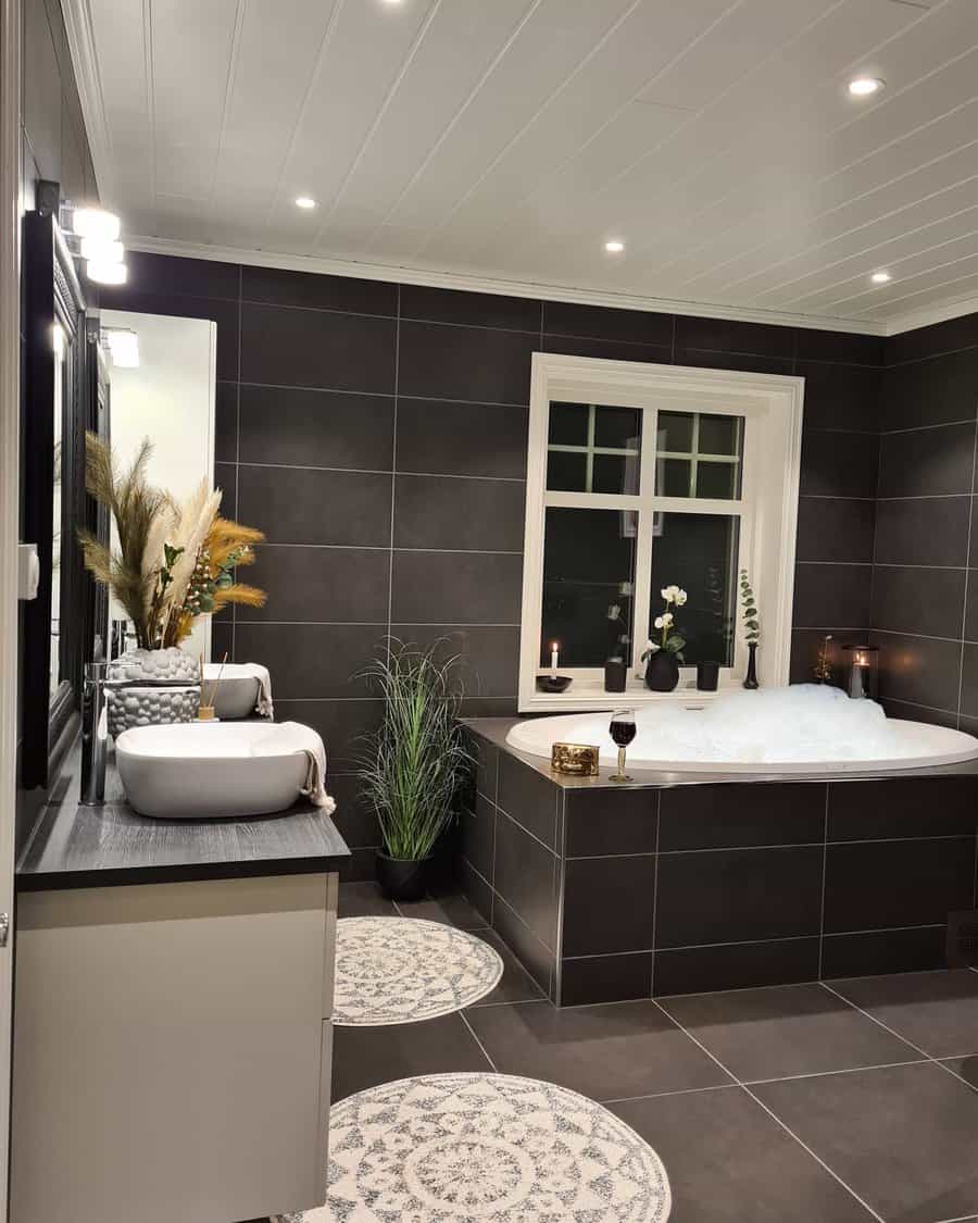 Luxurious dark tiled bathroom with spa tub