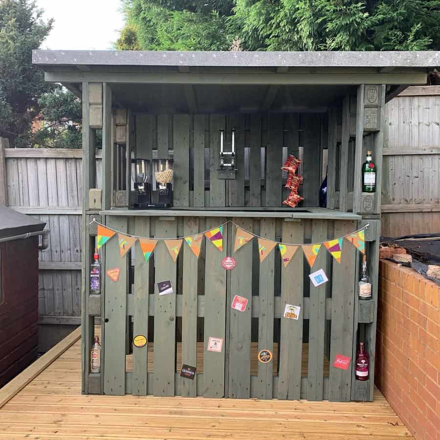 Compact garden bar with festive bunting and taps