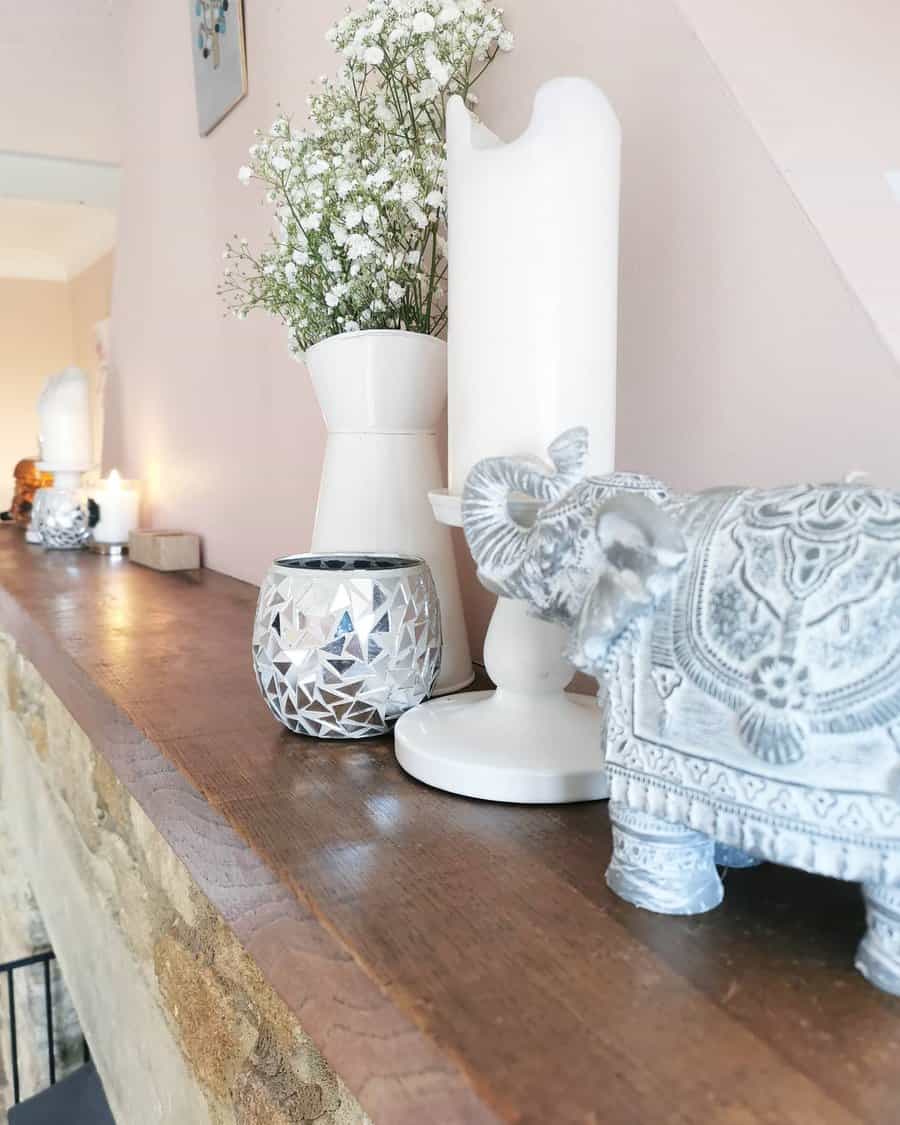 Mantelpiece with white vase and elephant decor