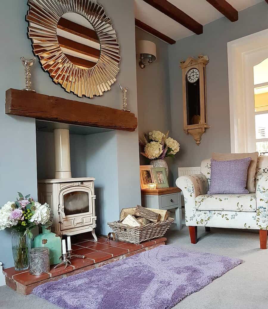 Chic living space with wood stove and sunburst mirror