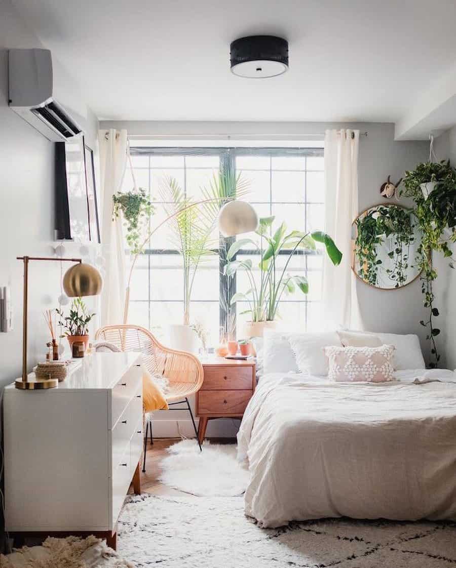 Living room with round mirror and hanging plants