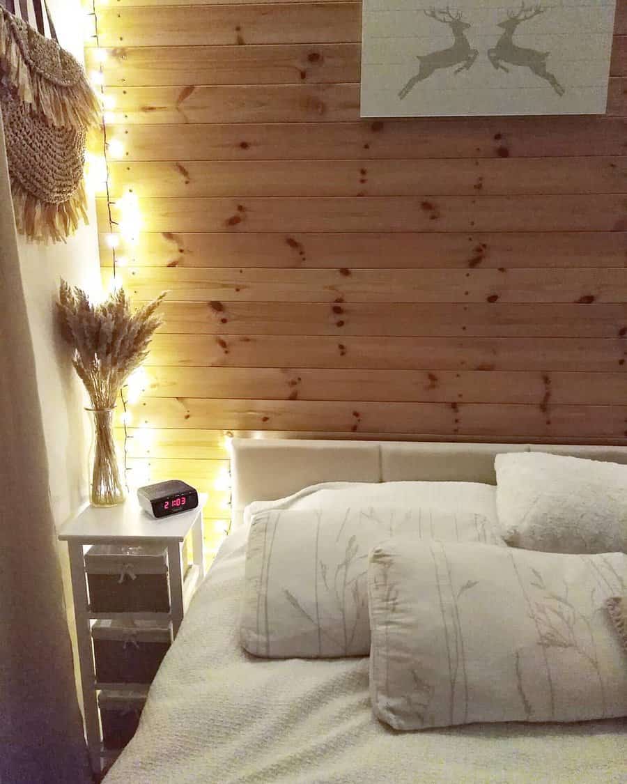 Cozy bedroom with pine wall and string lights