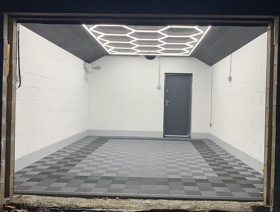 Garage with checkered floor and decorative ceiling lights