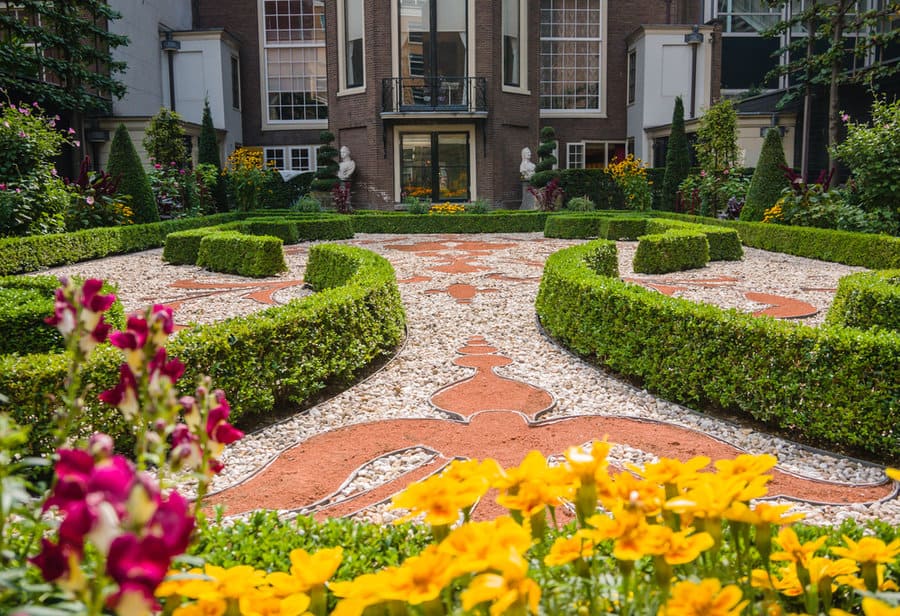 Formal garden with patterned hedges and flower beds