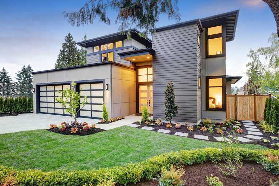 Contemporary home with neat lawn and square garden beds