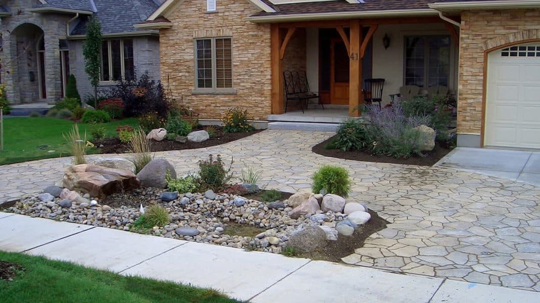 Driveway with rock garden and stone pathway to home