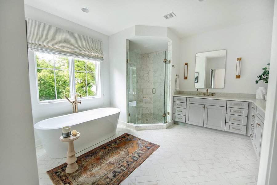 Spacious bathroom with freestanding tub and glass shower